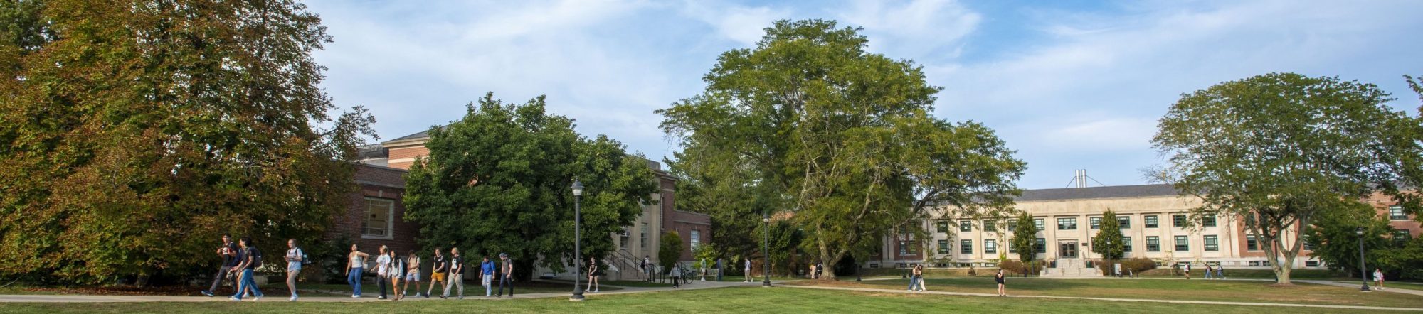 Group of students walking near the College of Agriculture, Health and Natural Resources, Young Building